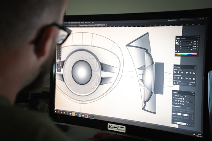 A designer shaping a product illustration on screen